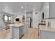 Stylish kitchen featuring a spacious island, stainless steel appliances, and seamless flow to living area at 6350 N Lisbon St, Aurora, CO 80019