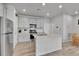 Charming kitchen featuring granite countertops, stainless steel appliances, white cabinets, and hardwood floors at 6350 N Lisbon St, Aurora, CO 80019