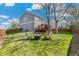Spacious backyard with lush lawn, mature trees, and a raised wooden deck at 9898 Mulberry Way, Highlands Ranch, CO 80129