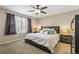 Cozy bedroom featuring neutral tones, a ceiling fan, and ample natural light at 9898 Mulberry Way, Highlands Ranch, CO 80129