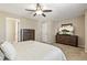 Spacious bedroom with a ceiling fan, closet, and dresser at 9898 Mulberry Way, Highlands Ranch, CO 80129