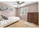 Bedroom with a window and shutters, carpeted floors, and a dark wood dresser at 9898 Mulberry Way, Highlands Ranch, CO 80129