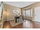 Elegant dining room with hardwood floors, bay window, and a black dining table at 9898 Mulberry Way, Highlands Ranch, CO 80129