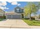 Charming two-story home featuring a three-car garage, a well-manicured lawn, and beautiful landscaping at 9898 Mulberry Way, Highlands Ranch, CO 80129