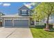 Beautiful home featuring a manicured front lawn, a three-car garage and classic architectural details at 9898 Mulberry Way, Highlands Ranch, CO 80129