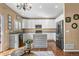 Well-lit kitchen boasts stainless steel appliances, granite countertops, and a stylish central island at 9898 Mulberry Way, Highlands Ranch, CO 80129