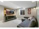 Finished basement with a mounted TV, a comfortable sofa, and a bright egress window at 9898 Mulberry Way, Highlands Ranch, CO 80129
