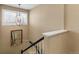 Well-lit staircase with a decorative chandelier and elegant railing at 9898 Mulberry Way, Highlands Ranch, CO 80129
