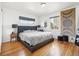 Cozy bedroom with a large bed, hardwood floors, and natural light at 1325 S Clermont St, Denver, CO 80222