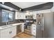 Updated kitchen with stainless steel appliances and white cabinets at 1325 S Clermont St, Denver, CO 80222