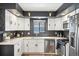 Updated kitchen featuring stainless steel appliances, tile backsplash, and ample cabinet space at 1325 S Clermont St, Denver, CO 80222