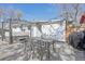 Relaxing outdoor patio area featuring a dining table, string lights, and hot tub at 1325 S Clermont St, Denver, CO 80222