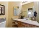 Bright bathroom with a decorative mirror, floral accents, and a neutral color palette at 13277 Elizabeth St, Thornton, CO 80241