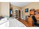 A well-lit bedroom with wood floors, closet system, and a view of the backyard at 13277 Elizabeth St, Thornton, CO 80241