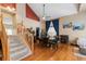 Bright dining room featuring hardwood floors, a decorative ceiling fan, and ample natural light from a large window at 13277 Elizabeth St, Thornton, CO 80241