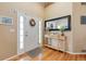 Inviting foyer with a neutral color scheme, hardwood floors, and a decorative mirror above a console table at 13277 Elizabeth St, Thornton, CO 80241
