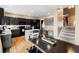 An open kitchen with a large island and stainless steel appliances, next to a large dining table at 13277 Elizabeth St, Thornton, CO 80241