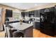 Well-equipped kitchen features a center island, black cabinets, and stainless steel appliances at 13277 Elizabeth St, Thornton, CO 80241