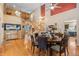 Open floor plan showcasing the staircase, dining area, and living room with wood floors at 13277 Elizabeth St, Thornton, CO 80241