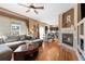 Cozy living room with a fireplace, hardwood floors, and an open layout into the dining area at 13277 Elizabeth St, Thornton, CO 80241