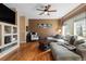 Comfortable living room with hardwood floors, a ceiling fan, and a large sectional sofa at 13277 Elizabeth St, Thornton, CO 80241