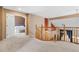 Second-floor loft area with a railing overlooking the dining area and an open doorway to a bedroom at 13277 Elizabeth St, Thornton, CO 80241
