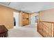 Bright loft area with carpeting, natural wood railing and doors, and versatile space at 13277 Elizabeth St, Thornton, CO 80241