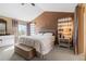 Vaulted ceiling main bedroom featuring tan walls, large window, and comfortable furniture at 13277 Elizabeth St, Thornton, CO 80241