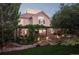 Inviting backyard with a pergola-covered patio, lush landscaping, and stone pathways for a relaxing outdoor experience at 1102 Buffalo Ridge Rd, Castle Pines, CO 80108