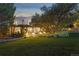 Expansive backyard featuring a covered patio and a serene water feature at 1102 Buffalo Ridge Rd, Castle Pines, CO 80108