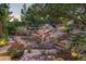 Stunning backyard waterfall feature with lush landscaping, stone pathways, and mature trees creating a serene outdoor oasis at 1102 Buffalo Ridge Rd, Castle Pines, CO 80108