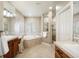 Bathroom with walk-in shower, soaking tub, wood cabinets and marble countertops at 1102 Buffalo Ridge Rd, Castle Pines, CO 80108