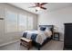 Cozy bedroom with a comfortable bed, bright window with shutters, and ceiling fan, creating a serene atmosphere at 1102 Buffalo Ridge Rd, Castle Pines, CO 80108