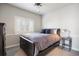 Bedroom featuring a full-size bed, a neutral color palette, and a window with privacy shutters at 1102 Buffalo Ridge Rd, Castle Pines, CO 80108