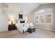 Bedroom with vaulted ceiling, large window, and decorative wall art above a metal bed frame at 1102 Buffalo Ridge Rd, Castle Pines, CO 80108