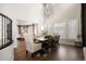 Bright dining room features hardwood floors, vaulted ceilings, and modern chandelier lighting at 1102 Buffalo Ridge Rd, Castle Pines, CO 80108