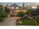 Beautiful home featuring a manicured lawn, mature trees, and an attached three-car garage at 1102 Buffalo Ridge Rd, Castle Pines, CO 80108