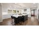 Open kitchen featuring an island with seating, white cabinets, and a large window at 1102 Buffalo Ridge Rd, Castle Pines, CO 80108