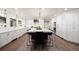 Spacious open kitchen with a large center island, modern lighting, and stainless appliances at 1102 Buffalo Ridge Rd, Castle Pines, CO 80108