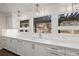 Bright kitchen with white cabinets, marble backsplash, and undermount sink at 1102 Buffalo Ridge Rd, Castle Pines, CO 80108