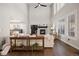 Open living room features fireplace, tall ceilings, and large windows at 1102 Buffalo Ridge Rd, Castle Pines, CO 80108