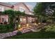 Wonderful outdoor patio area with stone features, pergola, and mature landscaping at 1102 Buffalo Ridge Rd, Castle Pines, CO 80108