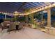 Covered outdoor dining area next to an illuminated rock waterfall feature at 1102 Buffalo Ridge Rd, Castle Pines, CO 80108