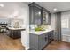 Stylish wet bar with a wine fridge next to a modern, bright kitchen at 1102 Buffalo Ridge Rd, Castle Pines, CO 80108