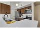 Modern kitchen with stainless steel appliances and breakfast bar at 4760 S Wadsworth Blvd # G304, Littleton, CO 80123