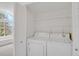Laundry area with washer and dryer near a sunlit room at 4760 S Wadsworth Blvd # G304, Littleton, CO 80123