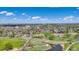 Expansive aerial view of a neighborhood showcasing nearby parks, a pond, and the community's green spaces at 6328 E Mississippi Ave, Denver, CO 80224