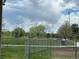 Scenic baseball field view, featuring well-maintained grass, fencing and mountain views against a dramatic sky at 6328 E Mississippi Ave, Denver, CO 80224