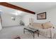 Finished basement with exposed beam, carpet, neutral paint, and a window at 6328 E Mississippi Ave, Denver, CO 80224