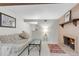 Finished basement with brick fireplace and mantle, carpet, and an open layout at 6328 E Mississippi Ave, Denver, CO 80224
